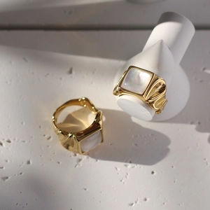 Macro shot of 18K gold plated wide band ring featuring square mother of pearl inlay