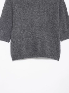 Close-up of dark grey knit fabric texture on a women's short sleeve POLO shirt