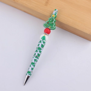 Detail of Christmas tree silicone topper with crystal rhinestones on a beaded ballpoint pen