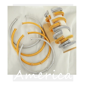 Detail showing gold and silver Tubogas coil bracelets with sparkling rhinestone nail design