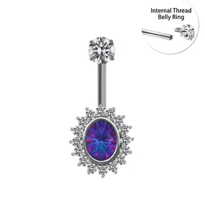 Detailed macro view of internal threading on a stainless steel navel ring with opal