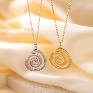 Detailed comparison of gold and silver spiral pendant necklaces on a stone base
