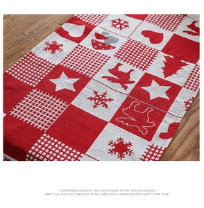 Close-up of red and white checkered Christmas table runner with snowflake and reindeer patterns