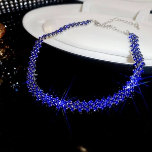 Detail of luxury geometric rhombus choker with blue and silver diamonds on display