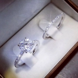 Macro view of a brilliant-cut stone and micro-pave diamonds on silver ring set