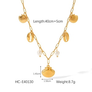 Detail of gold necklace with shell and pearl pendants showing size 40cm plus 5cm length