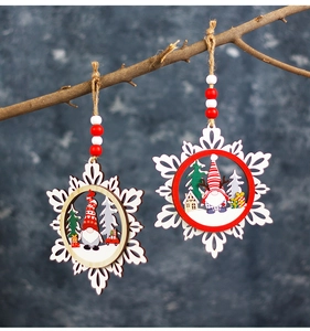 Detail of wooden snowflake ornaments with 3D gnomes and Christmas trees hanging on a branch