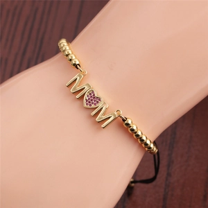 Gold MOM bracelet with pink heart-shaped crystal on female model arm wrist