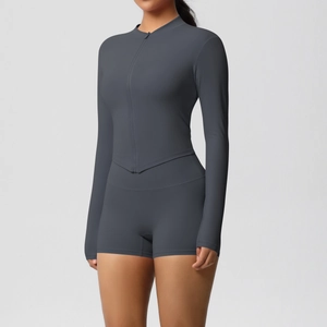 Detail view of dark grey yoga set with zip-up long sleeve top and high-waist shorts
