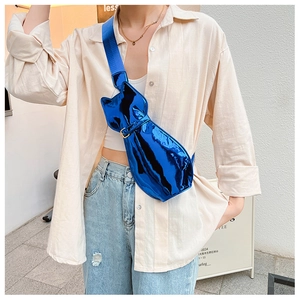 Close-up of metallic blue cat-shaped crossbody bag made of shiny patent leather material
