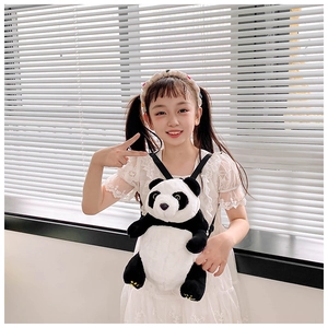 Detail of plush giant panda backpack with soft fur texture shown on a child model