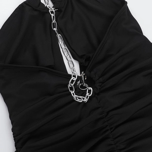 Detailed close-up of a black bodycon dress with silver metal chains on the neckline