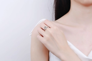 Close-up of S925 sterling silver V-shape moissanite ring worn on a woman finger