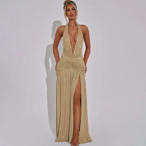 Detail of shimmering gold halter evening dress with deep V-neck and high leg slit