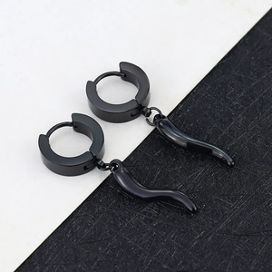 Close-up of polished black titanium steel hoop earrings with curved horn pendants