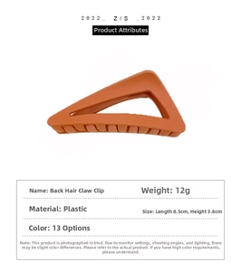Detailed view of orange triangular hair claw clip with measurements 8.5x3.8cm and 12g weight