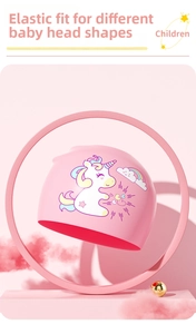 Detailed view of pink silicone swimming cap with cute unicorn and rainbow pattern