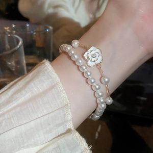 Elegant camellia flower and pearl double-layer bracelet set in gold finish
