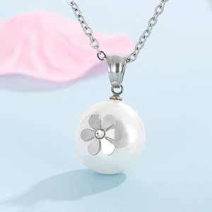 Detailed macro view of an elegant white pearl pendant with a silver floral setting