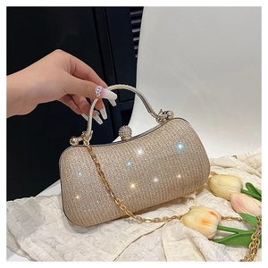 Detail showing shimmering champagne gold sequins and metallic spherical clasp on evening bag