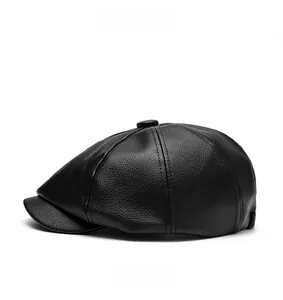 Detail of black leather newsboy cap showing textured finish and structured shape