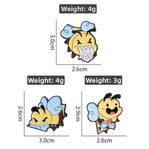 Close-up of three funny bee enamel pins with TAXES file and knife on white background