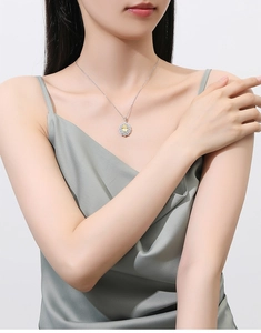 Detail of flower necklace with yellow gemstone and silver chain worn by a model