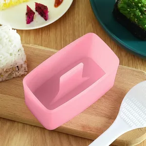 Pink sushi mold on wooden board showing non-stick material for rice ball making