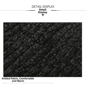 Macro detail of thick black chenille knit fabric showing warm textured material of the cap