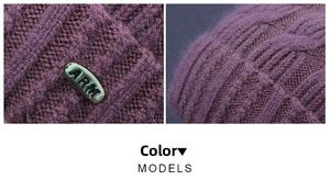 Detailed macro view of purple knitted hat texture with metallic ARM logo decoration