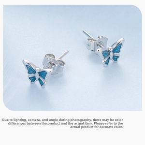 Macro shot of S925 sterling silver butterfly stud earrings with blue enamel wings