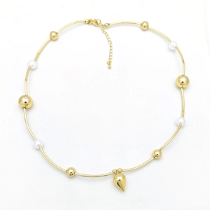 Detail of gold necklace featuring white pearls and a teardrop-shaped metal pendant