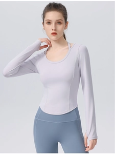 Detail of slim fit yoga top with thumbholes, curved hem, and professional seam work