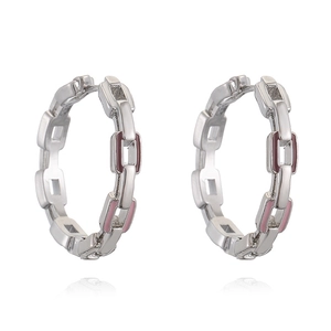 Detail shot of chain link earrings with pink and dark red enamel on polished silver metal