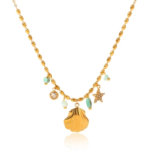 Macro shot of gold shell and starfish pendants with turquoise beads on a gold chain necklace