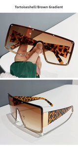 Detail of oversized tortoiseshell sunglasses with brown gradient lenses and stud accents