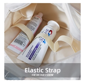 Detail view of the travel toiletry bag with elastic straps for securing toothpaste and tubes