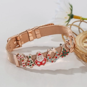 Macro shot of rose gold mesh bracelet with Christmas enamel charms and my angel engraving