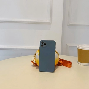 Detail of a dark blue matte silicone case for iPhone Pro shown with a yellow round bag