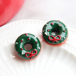 Macro shot of resin Christmas wreath donut charms for DIY phone cases and jewelry making
