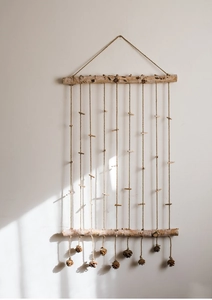 Detail of birch wood photo display wall hanging with hemp ropes and natural pine cones