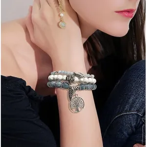 Bohemian 3-piece beaded bracelet set featuring tree of life and feather metal charms