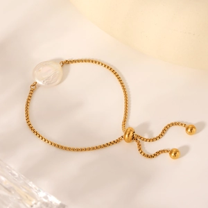 Adjustable golden stainless steel box chain bracelet featuring a large white freshwater pearl
