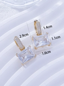 Detail view of rectangular zircon earrings with dimensions 2.9cm by 1.1cm in gold frame