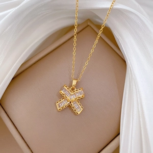Close-up of gold butterfly T-shaped necklace with crystals in a beige jewelry box