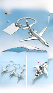 Detail view of zinc alloy airplane keychain showing rotating wheels and polished finish