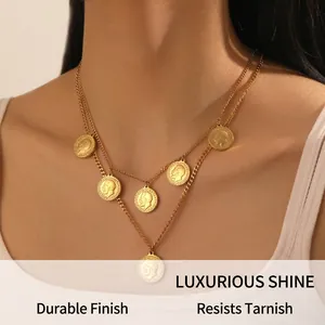 Detail of layered gold coin necklace showing embossed portraits and metallic texture