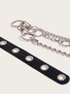 Detail of double-layer silver metal pants chain and black leather belt with silver eyelets