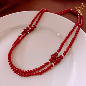 Double-layered dark red glass bead necklace with gold spacers and vintage elegant style