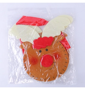 Detail of Christmas reindeer felt gift bag with red nose and handmade stitching